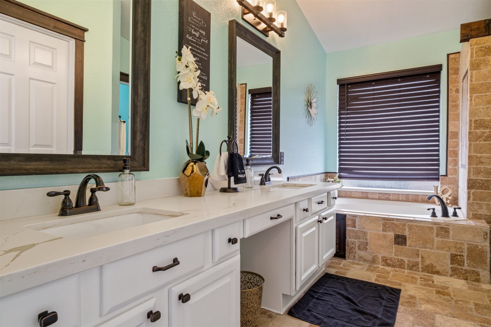 The primary bathroom features dual sinks, a jacuzzi tub, separate shower and water closet.