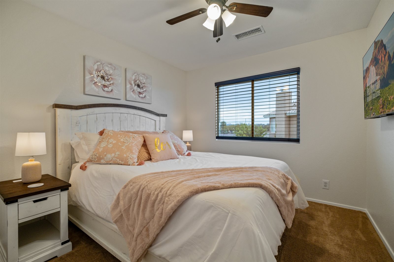 Bedroom 2 is located upstairs and has a Queen bed, TV and ceiling fan.