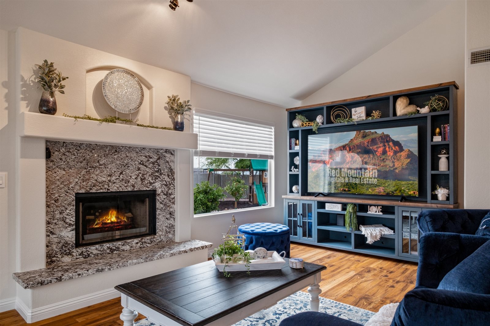 This living room is perfectly decorated and outfitted with a huge TV.